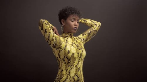 Femme afro-américaine en robe jaune vif à imprimé python