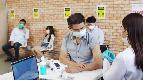 Medical Professional Giving Shot at Vaccination Site
