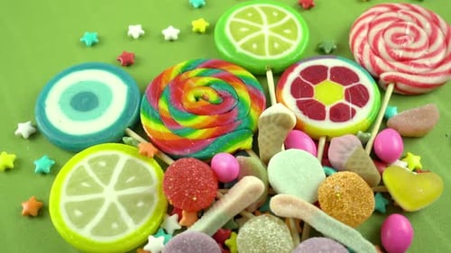 Colorful Candy and Lollipops on a Green Background
