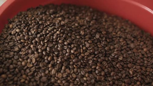 Close View of Pouring Coffee Beans Into Bowl