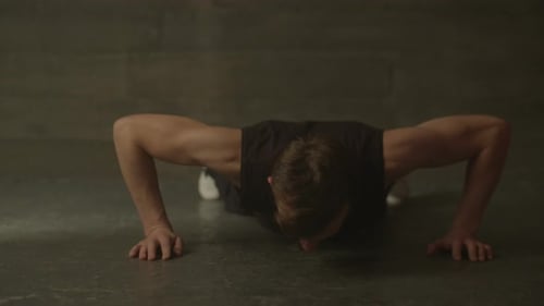 Fitness Muscular Man Doing Push-ups Exercise at Gym