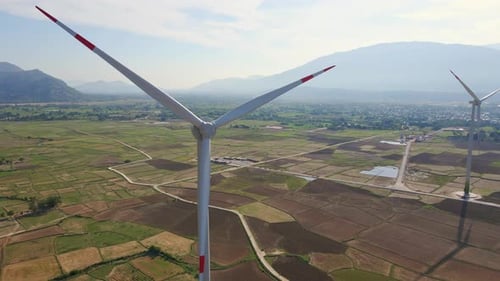 Aerial Shot of a Complex of Wind Turbines Standing on a Big Farming Field. Green Energy Concept