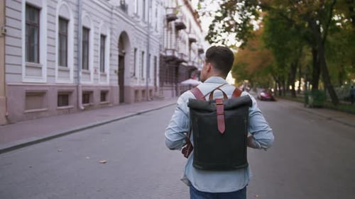 Attractive Young Handsome Man Tourist with Backpack Walking in City Center