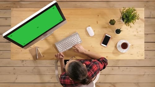 Young Casual Woman Working on Computer. Green Screen Mock-up Display