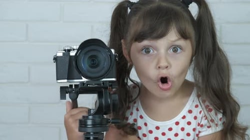 Young photographer. Curious child with camera.