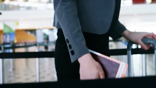 Passengers standing with boarding pass in queue
