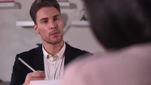 Businessman Has Interview with Woman Candidate at Table in Modern Office Spbi