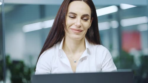 Woman Celebrating Success at her Office Job