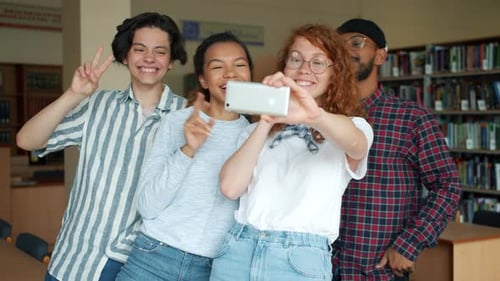 Slow Motion of Happy Friends Taking Selfie in University Library Having Fun