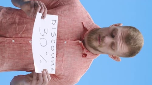 Young Man Holding Discount Sign