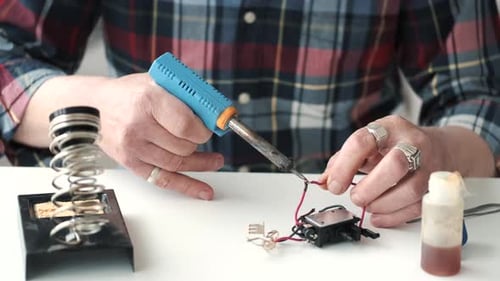 Soldering Wire on Electronic Component Close Up