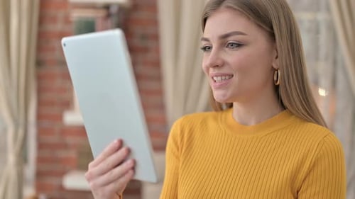 Woman Video Calling using Tablet Indoors