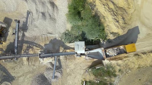 Open Pit Mining of Construction Sand Stone Materials with Excavators and Dump Trucks at Conveyor
