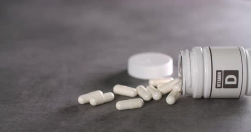 Vitamin D Capsules Spill from Bottle