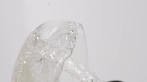Vertical video, Close-up of sparkling champagne being poured into a glass; bubbles in a glass