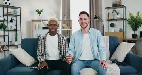 Young Couple Holding Hands on Couch