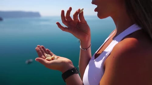 Woman Eating Milky Almond Nuts