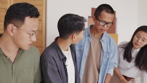 Team of Asian Architects Coworking in Office