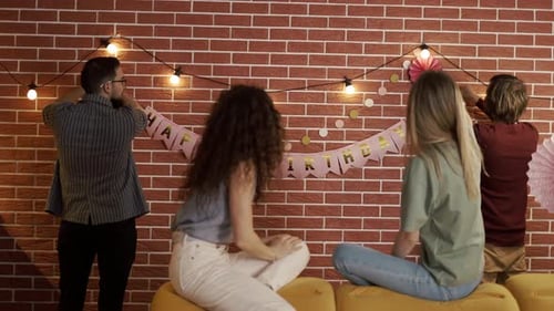 Friends Decorating Party Indoors for a Birthday Celebration