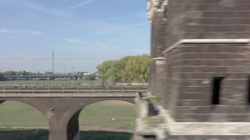 Commuter Train Passing Fast Over an Old Iron Bridge