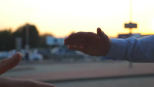 Dolly Shot of Young Colleagues Meeting on City Street and Having a Firm Friendly Handshake