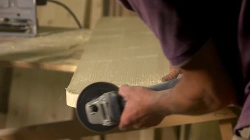 Close Up of Carpenter Polishing Wooden Board