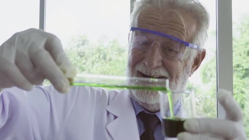 Senior Scientist Pouring Green Liquid in Laboratory