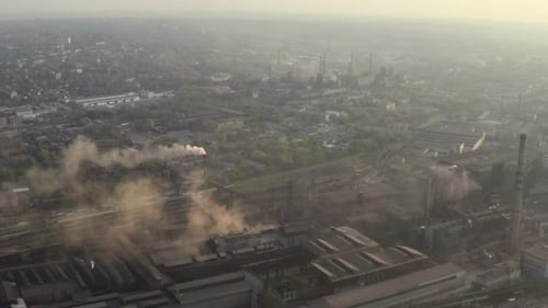 Smoke From The Plant Pipes Above The City Buildings