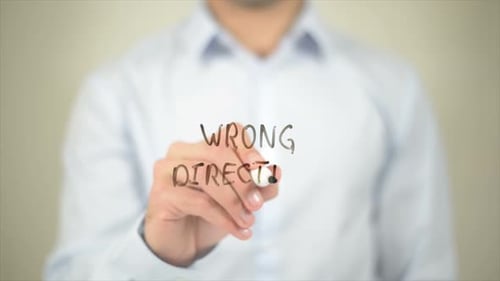 Wrong Direction Man Writing on Transparent Screen