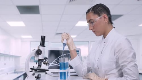 Young Adult Female Scientist Working in Lab