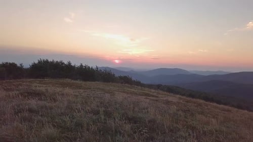 Sunset over Meadow in Mountains