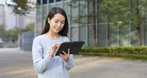 Woman Using Tablet in Urban Setting