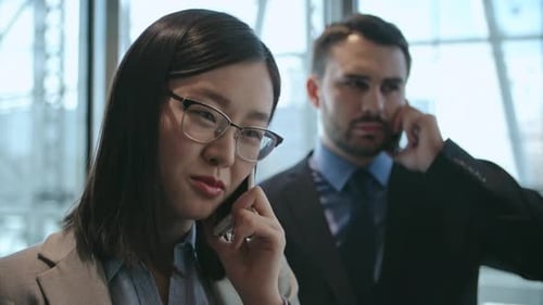 Businesspeople talking on mobile phones