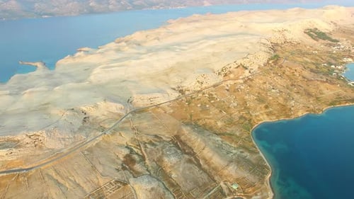Aerial view of road through barren landscape of Pag island in Croatia