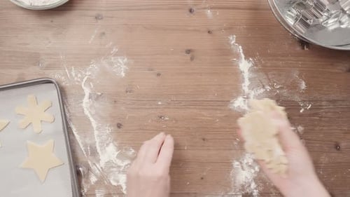 Person Rolling Out Sugar Cookie Dough for Baking