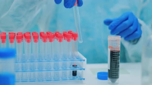Medical Professional Adds Blood to Test Tube