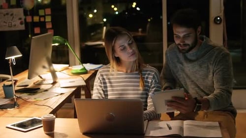 Team Working Late on Laptop and Tablet