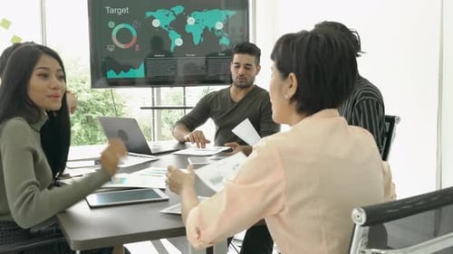 Office Meeting at Table with Technology Displayed