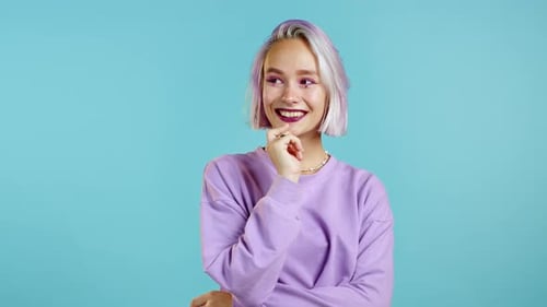 Attractive Hipster Woman with Colorful Purple Hair in Violet Wear Smiling, Flirting To Camera Over