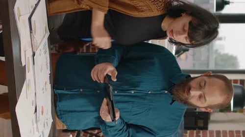 Colleagues Reviewing Data and Working Together at Office