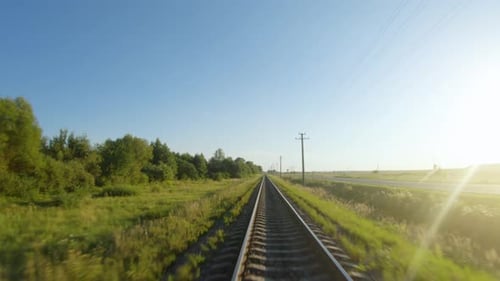 Moving Forward on Railroad Tracks Through Rural Landscape