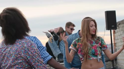 Friends Dancing at Rooftop Party in City
