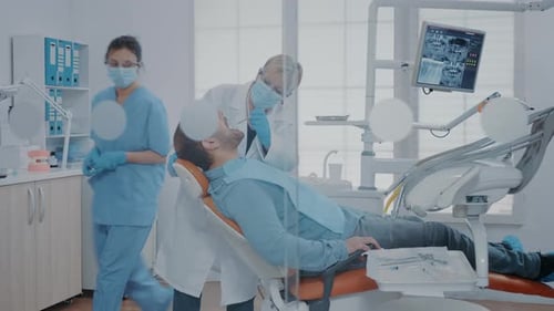 Dentist Examining Patient's Teeth in Clinic