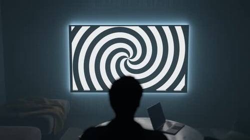 Darkroom with person watching TV with a hypnotic spiral on the screen. 4K render