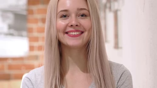 Portrait of Smiling Young Woman Loft Background