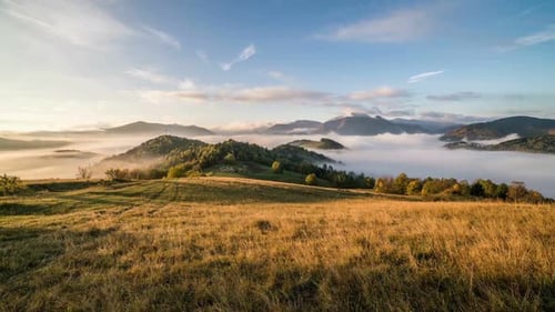 Serene Mountains and Foggy Landscape at Sunrise