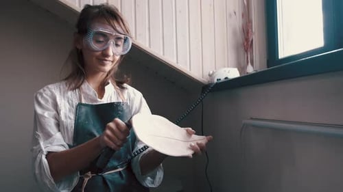 Woman Sculpting Clay Leaf in Art Studio