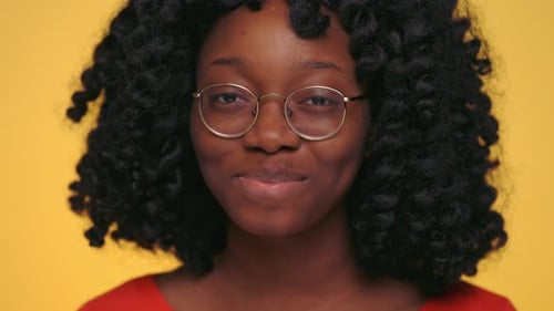 Pretty Dark Skinned Woman Winking and Smiling at Studio