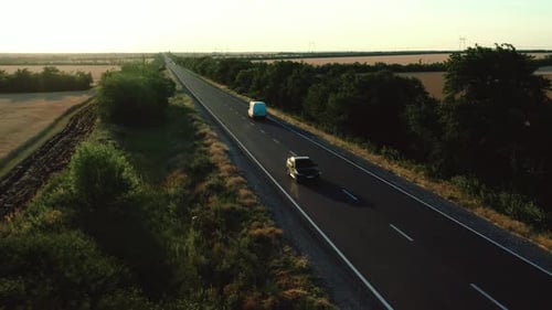 Flying High Over the Asphalt Road Among the Fields