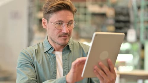 Man Using Tablet Device Indoors, Close Up